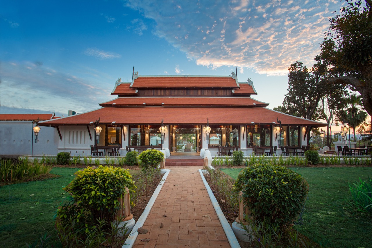 Sriwilai Restaurant — traditional Thai pavilion at dusk with lanterns and garden path