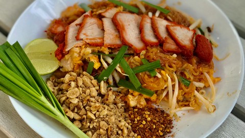 Pad Thai Sriwilai — thin rice noodles with roasted pork, crushed peanuts, and fresh lime